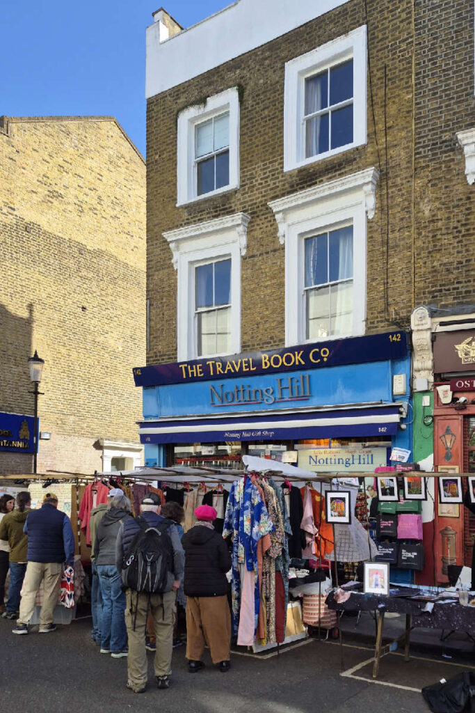 The Travel Book Co. Notting Hill Bookshop Nr. 142 Portobello Road mit Vintage-Kleiderständen davor