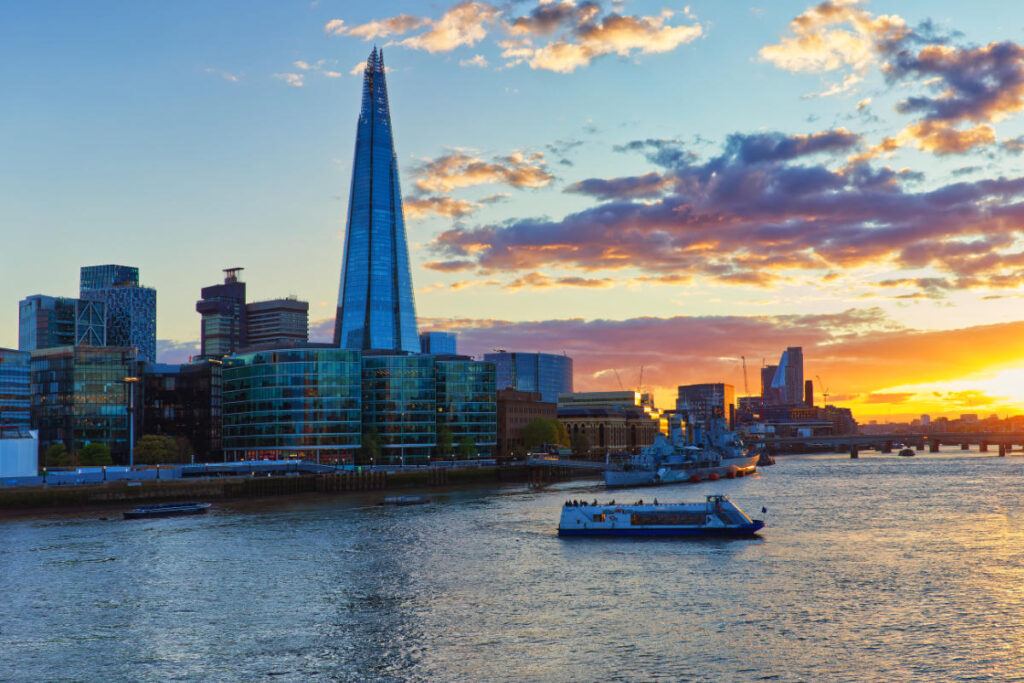 The Shard und Skyline von London in kräftigen Sonnenuntergangsfarben, Boote auf der Themse