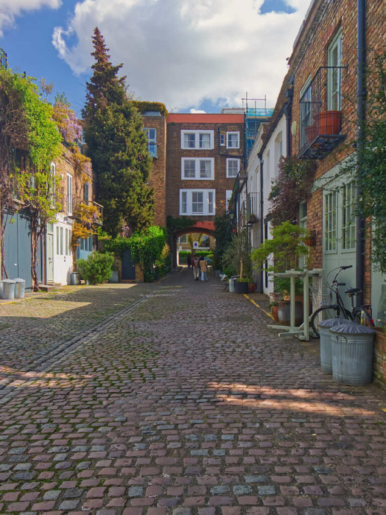 Blick durch die kopfsteingepflasterte St. Luke's Mews in Notting Hill Richtung Torbogen